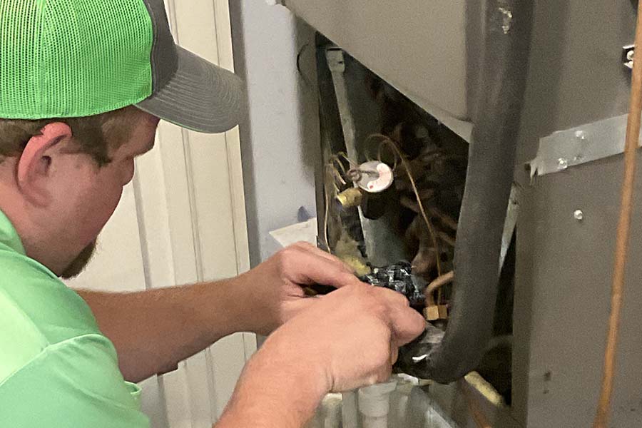 Technician performing furnace maintenance