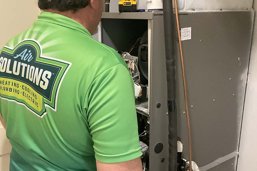 Air Solution technician performing air handler repair & installation