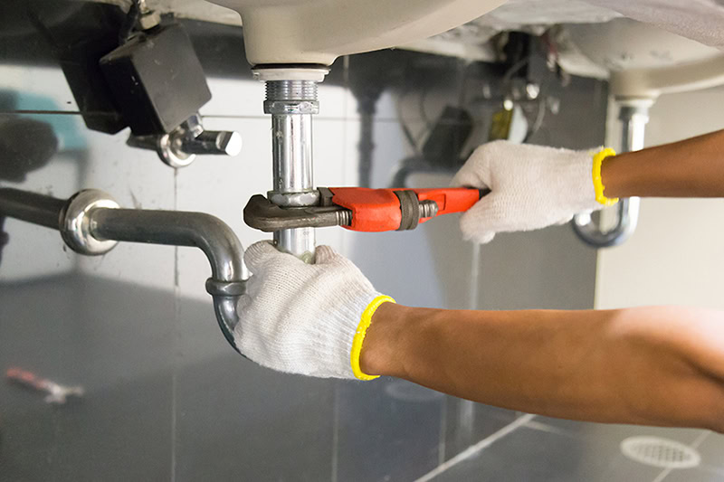 Plumber performing drain cleaning service