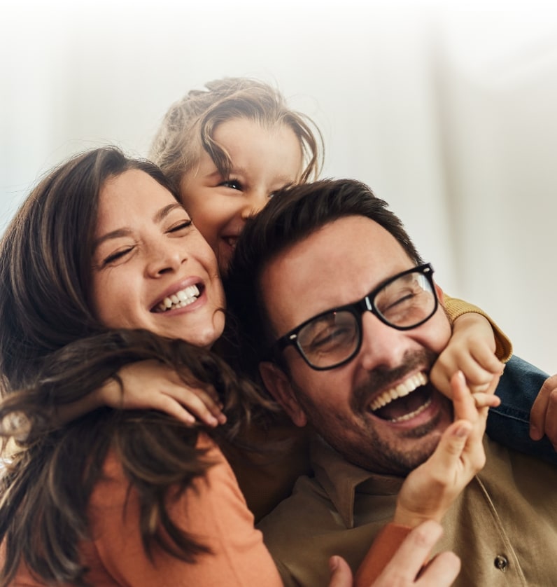 Happy family photo of man, woman, and child, for Air Solutions Heating, Cooling, Plumbing & Electrical financing section of home page.